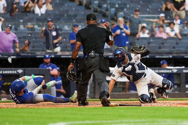 NEW YORK, NY - SEPTEMBER 06: Austin Wells #28 of the New York Yankees tags out Bo Bichette #11 of the Toronto Blue Jays at home plate during the game against the Toronto Blue Jays at Yankee Stadium on September 6, 2025 in New York, New York.