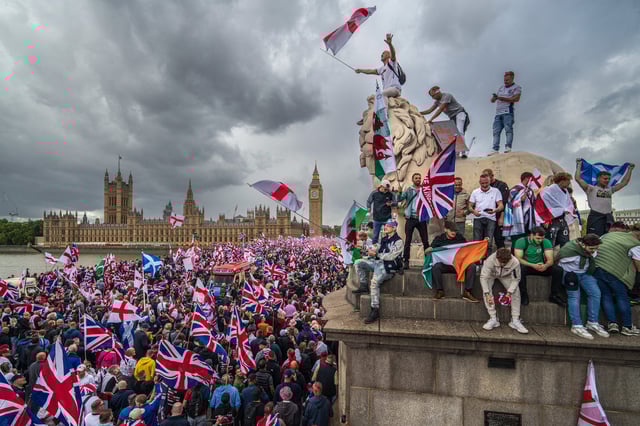 LONDON, ENGLAND - SEPTEMBER 13: Protesters wave Union Jack and St George's England flags during the "Unite The Kingdom" rally on Westminster Bridge by the Houses of Parliament on September 13, 2025 in London, England. Far-right activist Tommy Robinson (also known as Stephen Yaxley-Lennon) has invited supporters to hold a rally in central London entitled "Unite The Kingdom". The former English Defence League leader and his supporters are actively islamophobic and racist and have been behind much of the unrest seen outside hotels housing migrants this summer. Stand Up To Racism are mounting a counter-protest to today's rally.  (Photo by Christopher Furlong/Getty Images)