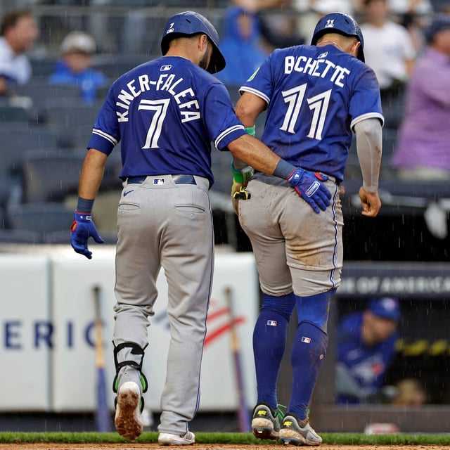 Toronto Blue Jays' Bo Bichette (11) is helped off the field by Isiah Kiner-Falefa (7) after being tagged out at home during the sixth inning of a baseball game agains the New York Yankees, Saturday, Sept. 6, 2025, in New York. (AP Photo/Adam Hunger)