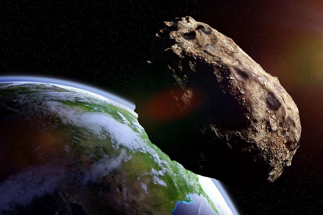 Stock image of an asteroid approaching planet Earth.