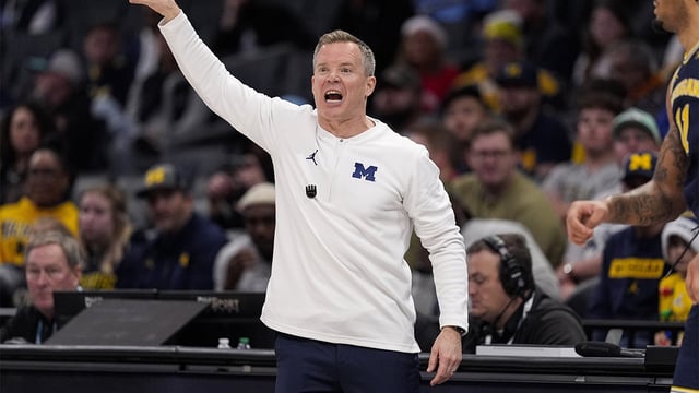 Dec 18, 2024; Charlotte, North Carolina, USA; Michigan Wolverines head coach Dusty May yells to his team during the first half against the Oklahoma Sooners at Spectrum Center. Mandatory Credit: Jim Dedmon-Imagn Images