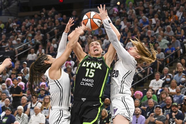 Minnesota Lynx forward Jessica Shepard goes up to shoot between Golden State Valkyries center Iliana Rupert, left, and guard Kate Martin during the second half of Game 1 in the first round of the WNBA basketball playoffs Sunday, Sept. 14, 2025, in Minneapolis.