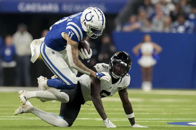 Jan 5, 2025; Indianapolis, Indiana, USA; Indianapolis Colts wide receiver Michael Pittman Jr. (11) falls over Jacksonville Jaguars safety Darnell Savage (6) during a game against the Jacksonville Jaguars at Lucas Oil Stadium. Mandatory Credit: Christine Tannous/USA TODAY Network via Imagn Images/File Photo