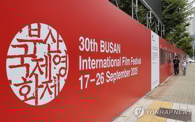 People walk past a signboard for the Busan International Film Festival near the Busan Cinema Center in Haeundae, Busan, southeastern South Korea, on Sept. 15, 2025. (Yonhap)