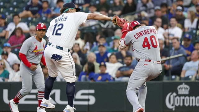Sep 9, 2025; Seattle, Washington, USA; Seattle Mariners first baseman Josh Naylor (12) tags out St. Louis Cardinals first baseman Wilson Contreras (40) during the third inning at T-Mobile Park. Mandatory Credit: Joe Nicholson-Imagn Images