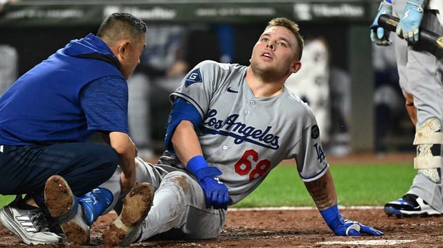 Sep 5, 2025; Baltimore, Maryland, USA; Los Angeles Dodgers catcher Dalton Rushing (68) sits on the ground after a foul ball off his leg during the sixth inning against the Baltimore Orioles at Oriole Park at Camden Yards. Mandatory Credit: James A. Pittman-Imagn Images