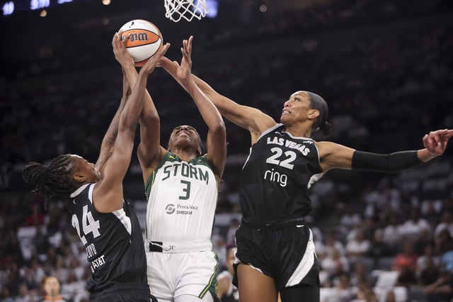 Jewell Loyd #24 and A'ja Wilson #22 of the Las Vegas Aces defend a shot from Nneka Ogwumike #3 of the Seattle Storm in the second quarter of Game One of the 2025 WNBA Playoffs first round at Michelob ULTRA Arena on September 14, 2025 in Las Vegas, Nevada.