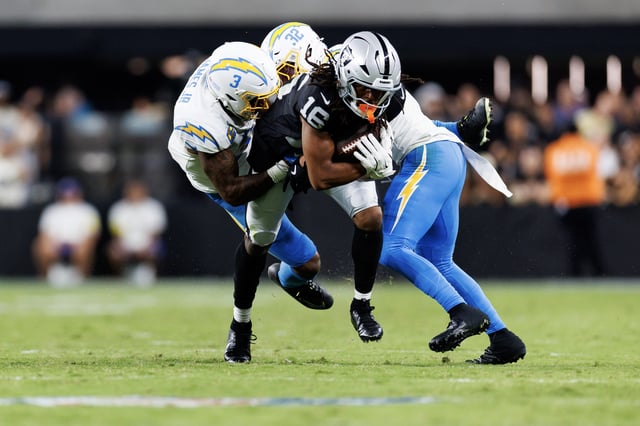 LAS VEGAS, NEVADA - SEPTEMBER 15: Jakobi Meyers #16 of the Las Vegas Raiders carries the ball against Derwin James Jr. #3 of the Los Angeles Chargers and Alohi Gilman #32 during an NFL football game at Allegiant Stadium on September 15, 2025 in Las Vegas, Nevada. (Photo by Brooke Sutton/Getty Images)