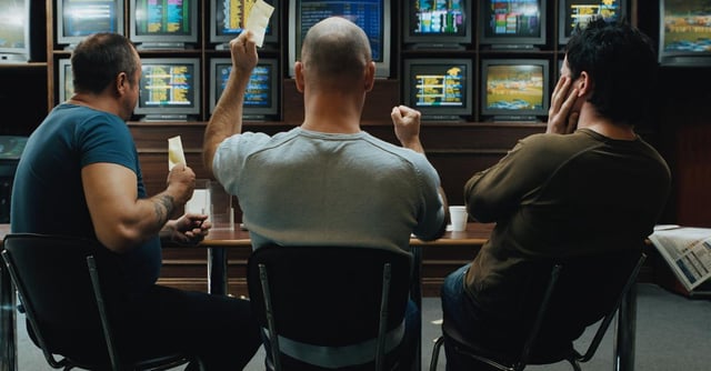 Men in a sports betting parlor. | Getty Images