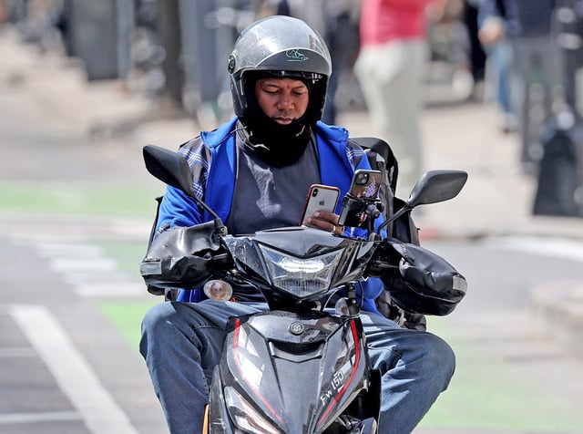 Boston, MA - Sept. 16 -  A delivery driver rides a scooter along Boylston Street. (Photo By Matt Stone/Boston Herald)