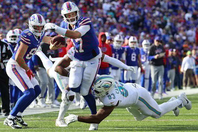 ORCHARD PARK, NEW YORK - NOVEMBER 03: Josh Allen #17 of the Buffalo Bills carries the ball against Calais Campbell #93 of the Miami Dolphins during the second quarter at Highmark Stadium on November 03, 2024 in Orchard Park, New York.