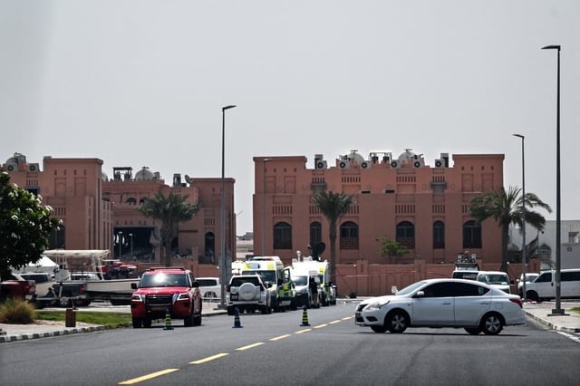 A picture taken from a distance shows the damaged building (L) in the compound housing members of Palestinian militant group Hamas's political bureau which was targeted the previous day by an Israeli strike in Qatar's capital Doha, on September 10, 2025. (Photo by -/AFP via Getty Images)
