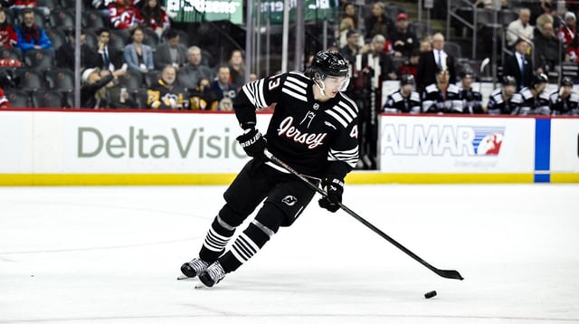 Apr 11, 2025; Newark, New Jersey, USA; New Jersey Devils defenseman Luke Hughes (43) skates with the puck during the third period against the Pittsburgh Penguins at Prudential Center. Mandatory Credit: John Jones-Imagn Images