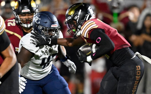Mikhal Johnson #42 of Sierra Canyon tackles Gavin Ingram #0 of Downey in the first half. Downey hosted Sierra Canyon in a boys football game on Sept. 12, 2025 in Downey CA. (Photo by John McCoy, Contributing Photographer)