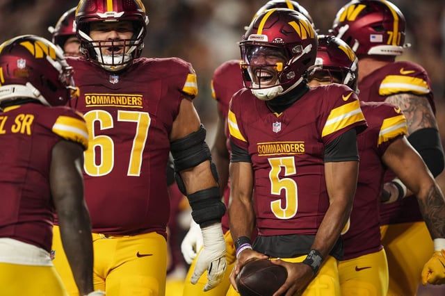 Jayden Daniels #5 of the Washington Commanders celebrates during an NFL preseason football game against the Cincinnati Bengals at Northwest Stadium on August 18, 2025 in Landover, Maryland.