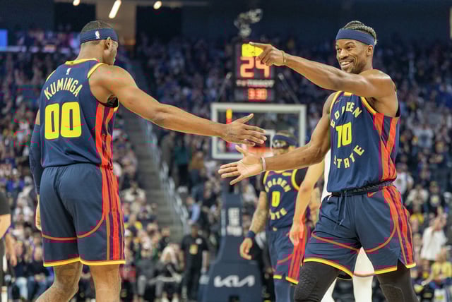 Jimmy Butler of the Golden State Warriors celebrates scoring with teammate Jonathan Kuminga, left, during the 2024-2025 NBA regular season game between the Golden State Warriors and the New York Knicks in San Francisco on March 15, 2025.