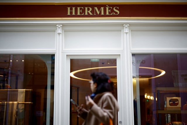 A woman walks past a Hermes store in Nantes, France, October 17, 2024. REUTERS/Stephane Mahe/File Photo