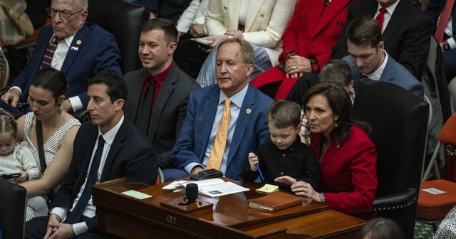 Texas Attorney General Ken Paxton sits with his wife and state Sen. Angela Paxton, R-McKinney, during the opening of the 2025 Legislative Session in Austin on Tuesday, Jan. 14, 2025.