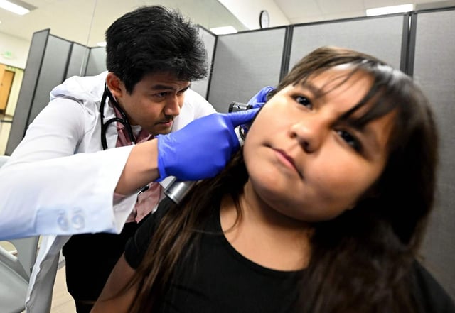Sofia Delarosa, 10, has her ears checked by nurse practitioner Benedict Malinao on Thursday, Aug. 14, 2025, at the Inland Empire Health Plan’s Community Wellness Clinic in San Bernardino. Due to recent changes, as many as 300,000 people enrolled in Medi-Cal through the health plan could lose insurance in the coming years. (Photo by Will Lester, Inland Valley Daily Bulletin/SCNG)