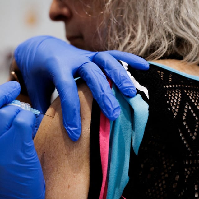 A person receives a dose of the Pfizer-BioNTech coronavirus disease (COVID-19) vaccine from Skippack Pharmacy during the Senior Fair at Trinity Lutheran Church in Lansdale, Pennsylvania, U.S. September 4, 2025.  REUTERS/Hannah Beier