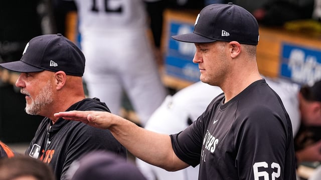 Detroit Tigers pitcher Paul Sewald (62), right, talks to assistant pitching coach Robin Lund in the dugout before the game against Minnesota Twins at Comerica Park in Detroit in Monday, August 4, 2025.