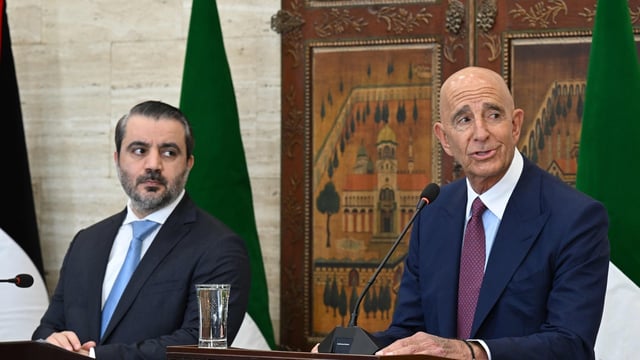 Syrian Foreign Minister Asaad al-Shaibani (L) watches as US special envoy for Syria Tom Barrack speaks.