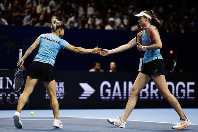 Tennis - Billie Jean King Cup Finals - Quarter Finals - Kazakhstan v United States - Shenzhen Bay Sports Centre Arena, Shenzhen, China - September 18, 2025 Kazakhstan's Elena Rybakina and Yulia Putintseva reacts during their doubles match against Jessica Pegula and Taylor Townsend of the U.S. REUTERS/Tingshu Wang
