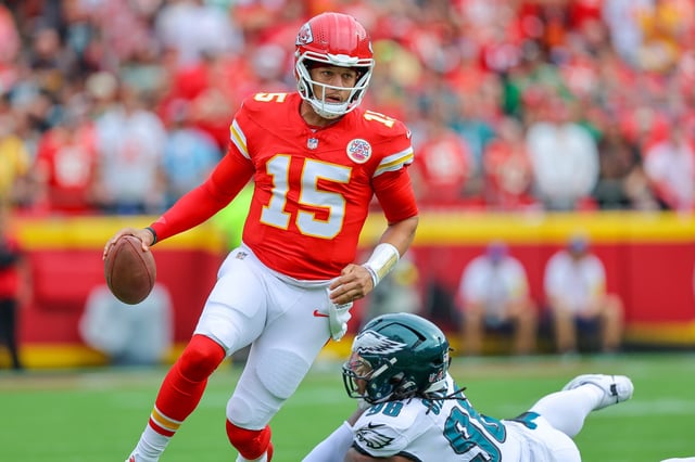 Patrick Mahomes #15 of the Kansas City Chiefs runs from Jalen Carter #98 of the Philadelphia Eagles in the first quarter during the NFL 2025 game between Philadelphia Eagles and Kansas City Chiefs at Arrowhead Stadium on September 14, 2025 in Kansas City, United States.