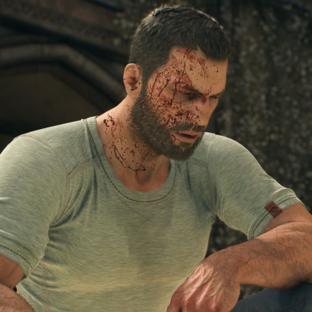 Kyle Crane, the protagonist from Dying Light: The Beast, sitting outside after an injury. He's in a plain white t-shirt and jeans, squinting with a bloody face.