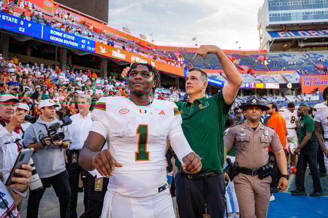 Head coach Mario Cristobal introduces senior quarterback Cam Ward to Miami Hurricanes fans after beating the University of Florida Gators at Ben Hill Griffin Stadium on August 31, 2024.