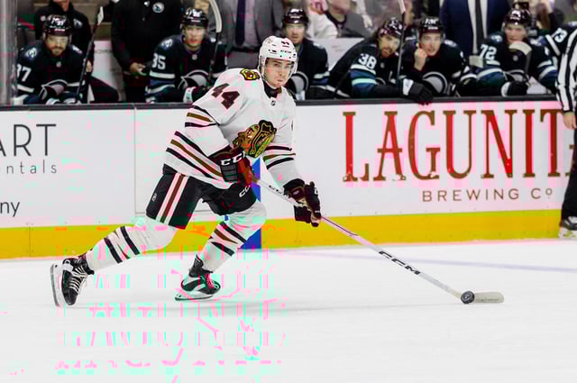 Mar 13, 2025; San Jose, California, USA; Chicago Blackhawks defenseman Wyatt Kaiser (44) skates with the puck during the first period against the San Jose Sharks at SAP Center at San Jose. Mandatory Credit: Bob Kupbens-Imagn Images/File Photo