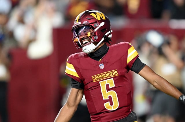 Jayden Daniels #5 of the Washington Commanders celebrates after rushing for a touchdown in the first quarter against the Cincinnati Bengals during the NFL Preseason 2025 game at Northwest Stadium on August 18, 2025 in Landover, Maryland.