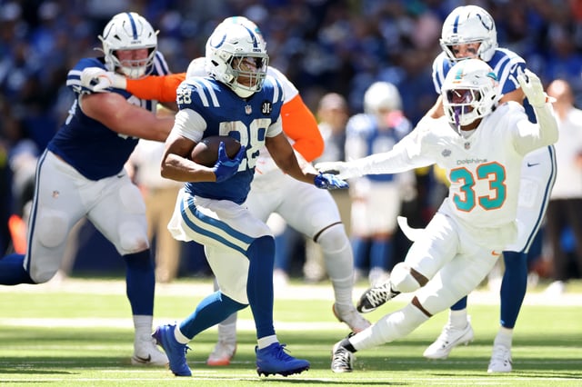 INDIANAPOLIS, INDIANA - SEPTEMBER 07: Jonathan Taylor #28 of the Indianapolis Colts runs the ball against Jason Marshall Jr. #33 of the Miami Dolphins during the second quarter during the game at Lucas Oil Stadium on September 07, 2025 in Indianapolis, Indiana