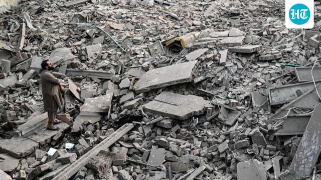 (FILES) Locals stand on the debris of destroyed structures in Muridke 30 kilometres from Lahore on May 7, 2025, after Indian strikes. (AFP)