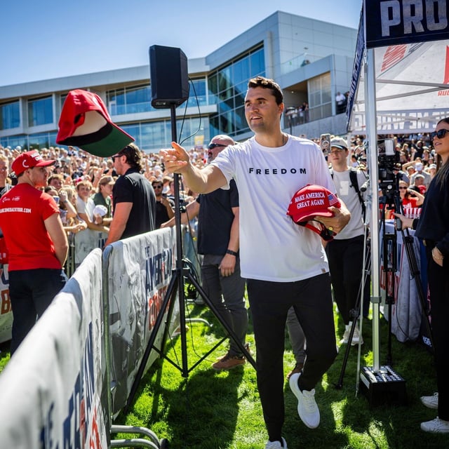 Charlie Kirk hands out hats before speaking at Utah Valley University in Orem, Utah, Wednesday, Sept. 10, 2025. (Tess Crowley/The Deseret News via AP)