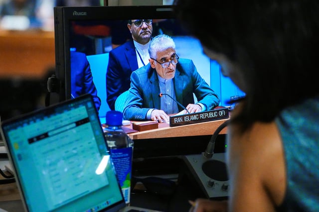 Iran’s Ambassador to the United Nations, Amir-Saeid Iravani, is seen on a screen as he addresses members of the U.N. Security Council after a vote on a resolution that would permanently lift U.N. sanctions on Iran, at U.N. headquarters in New York City, U.S., September 19, 2025. REUTERS/Eduardo Munoz