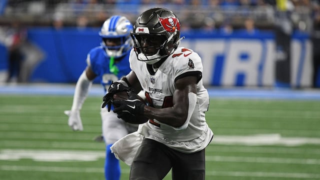 Sep 15, 2024; Detroit, Michigan, USA; Tampa Bay Buccaneers wide receiver Chris Godwin (14) scores a touchdown against the Detroit Lions in the second quarter at Ford Field. Mandatory Credit: Eamon Horwedel-Imagn Images