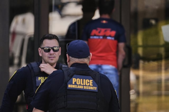 Department of Homeland Security police officers are stationed at the front door of the U.S. Immigration and Customs Enforcement regional field office, Tuesday, Sept. 16, 2025, in Burlington, Mass.