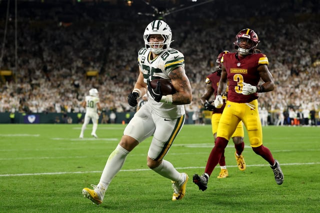 GREEN BAY, WISCONSIN - SEPTEMBER 11: Tucker Kraft #85 of the Green Bay Packers scores an 8 yard touchdown against the Washington Commanders during the fourth quarter in the game at Lambeau Field on September 11, 2025 in Green Bay, Wisconsin.