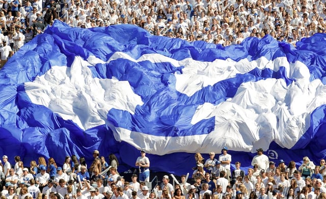 Fans in the student section hold up a BYU banner during a football game at LaVell Edwards Stadium in Provo on Saturday, Oct. 15, 2022.