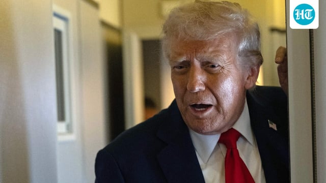 President Donald Trump speaks to the press as he flies back to the United States from the United Kingdom