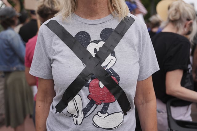 Black tape crosses out a Mickey Mouse T-shirt during a demonstration in response to the suspension of Jimmy Kimmel's late-night show outside of The Walt Disney Studios Thursday, Sept. 18, 2025, in Burbank, Calif. (AP Photo/Jae C. Hong)