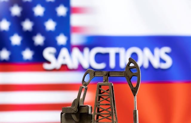 A model of a pump jack is seen in front of the displayed word "Sanctions",  U.S. and Russia flag colours in this illustration taken March 8, 2022. REUTERS/Dado Ruvic/Illustration/File Photo
