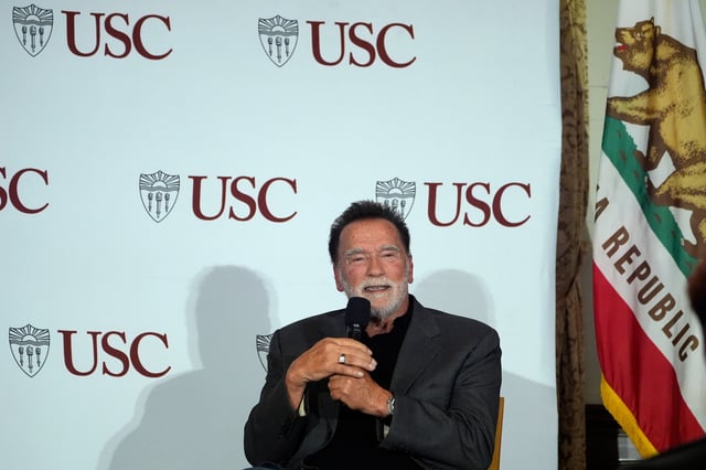 Former California Gov. Arnold Schwarzenegger, right, expresses his opposition to Proposition 50, a California ballot measure to redraw U.S. House maps to boost Democrats, during a conversation with University of Southern California interim president Beong-Soo Kim, not shown, on democracy at the USC campus in Los Angeles, Monday, Sept. 15, 2025 (AP Photo/Damian Dovarganes)