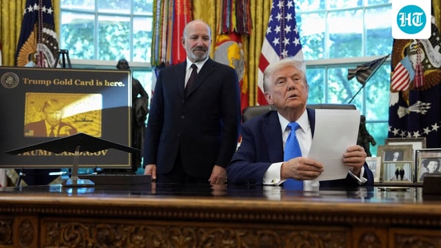 President Donald Trump with Secretary of Commerce Howard Lutnick they announce the new H-1B visa fee in the Oval Office 
