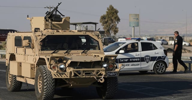 Israeli troops arrive at the Allenby Bridge crossing, after two members of the country's military were killed at the site. AP