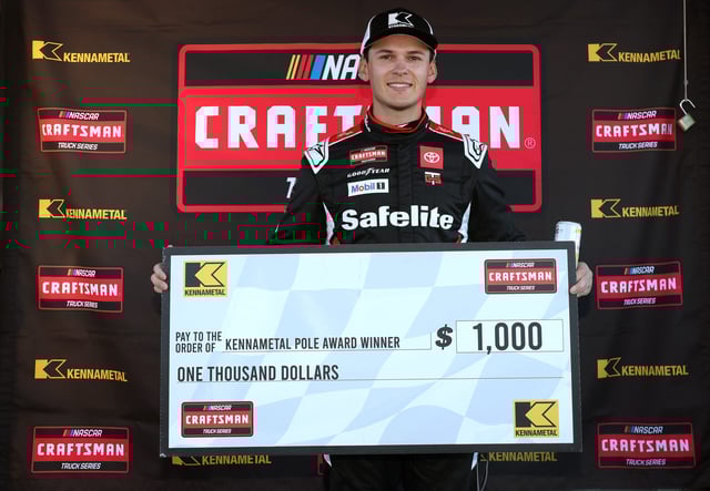 LOUDON, NEW HAMPSHIRE - Corey Heim, driver of the #11 Safelite Toyota, poses with the pole award winner $1,00.00 check during qualifying for the NASCAR Craftsman Truck Series Team EJP 175 at New Hampshire Motor Speedway on September 19, 2025 in Loudon, New Hampshire. (Photo by Meg Oliphant/Getty Images)