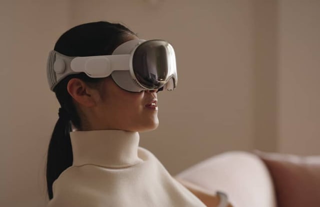 Woman wearing an Apple Vision Pro headset indoors.