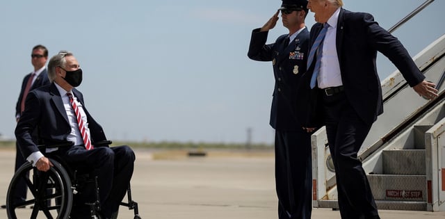 U.S. President Donald Trump is greeted by Texas Governor Greg Abbott as he arrives at Midland International Air and Space Port in Midland, Texas, U.S., July 29, 2020. REUTERS/Carlos Barria