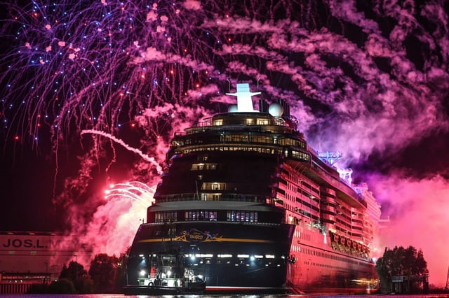 Disney Cruise Line’s Disney Destiny leaves the Meyer Werft shipyard towards Eemshaven, Netherlands, with a fireworks display from Papenburg, Germany, Friday, Sept. 19, 2025. (Lars Penning/dpa via AP)